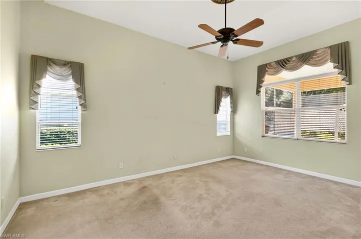 Spare room featuring light carpet and a ceiling fan