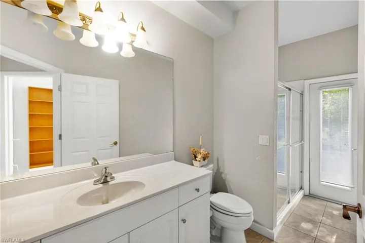 Bathroom featuring vanity, a stall shower, and light tile patterned floors