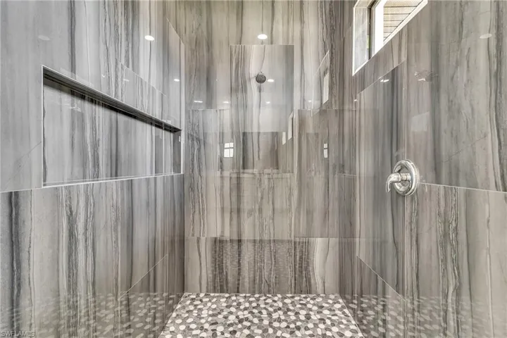 Full bath featuring a tile shower