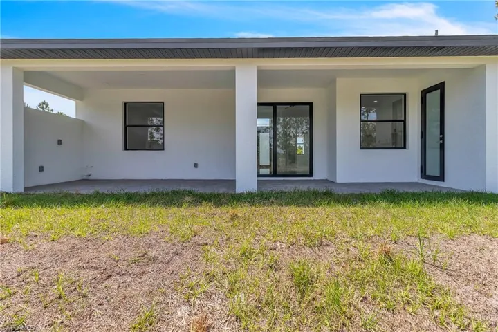Rear view of house with stucco siding