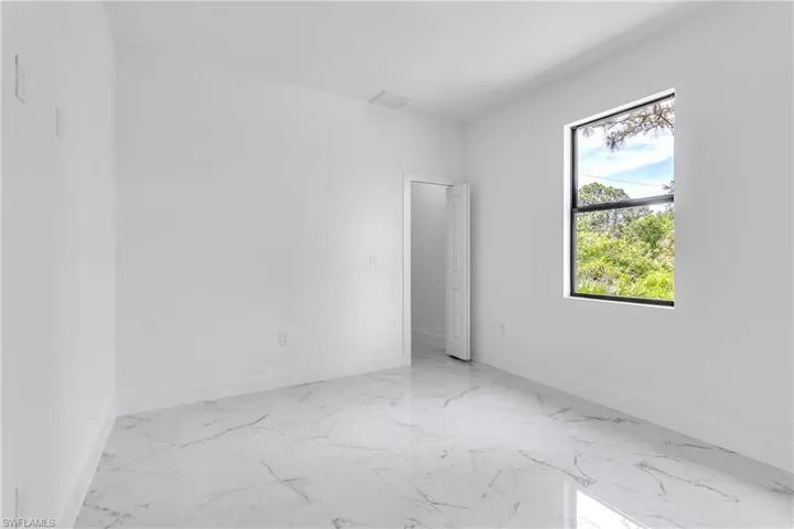 Empty room with marble finish flooring and baseboards