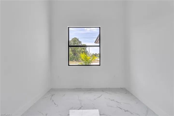 Empty room with marble finish floors and baseboards