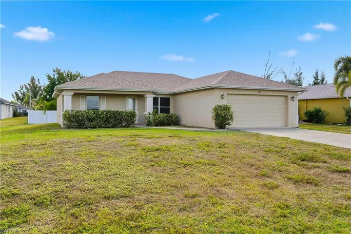 Ranch-style house with stucco siding, concrete driveway, and a garage