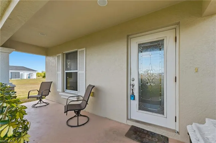 Entrance to property featuring stucco siding and a patio
