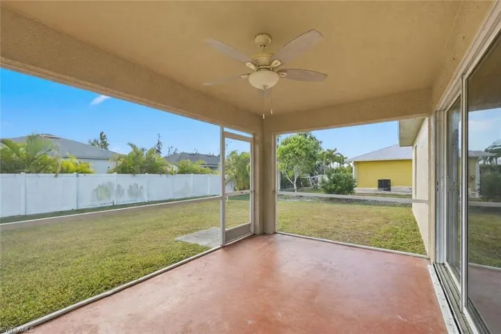 Unfurnished sunroom featuring a ceiling fan