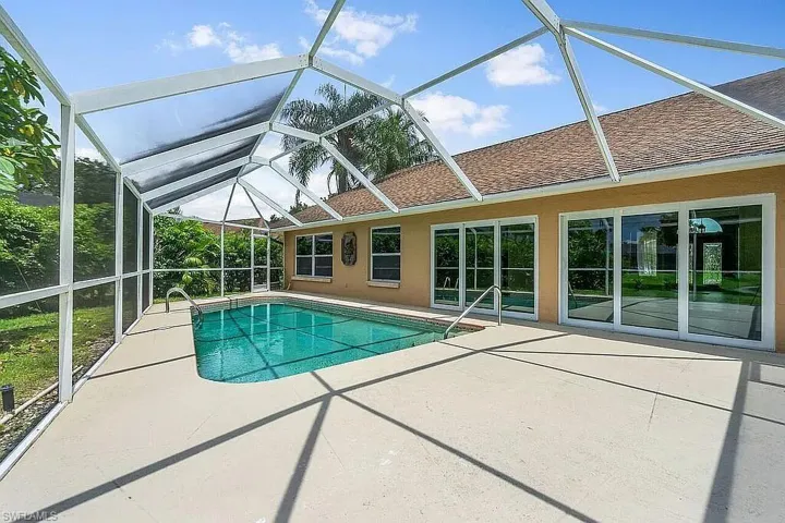 Outdoor pool featuring a lanai and a patio area