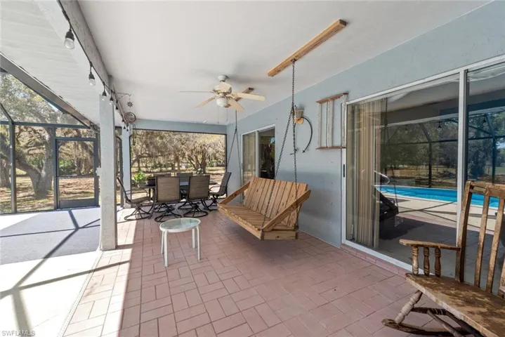 Sunroom / solarium featuring ceiling fan, outdoor dining area, a patio area, and plenty of natural light
