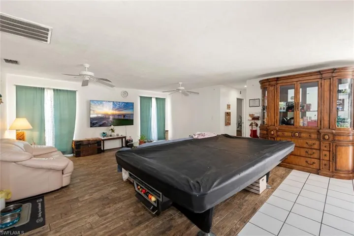 Playroom with wood finished floors, pool table, and ceiling fan