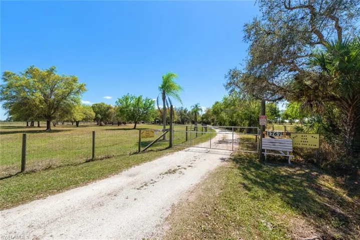 View of street with a gate and a gated entry
