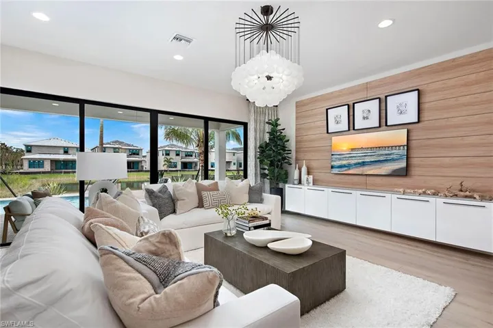 Living room featuring light wood-type flooring and wood walls