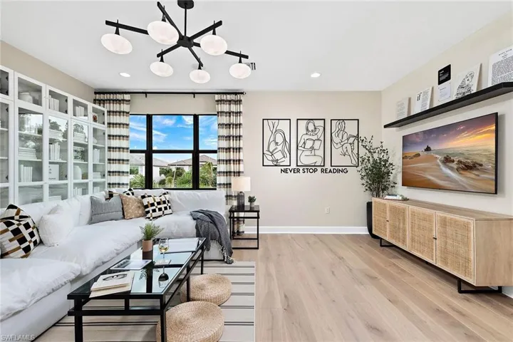 Living room with a chandelier and light hardwood / wood-style floors