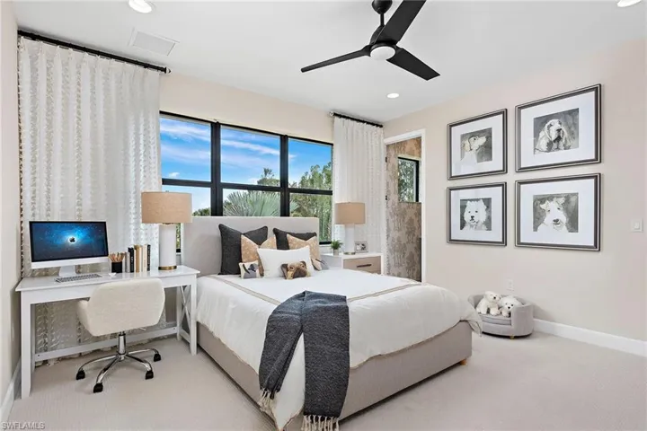 Bedroom with ceiling fan and light colored carpet