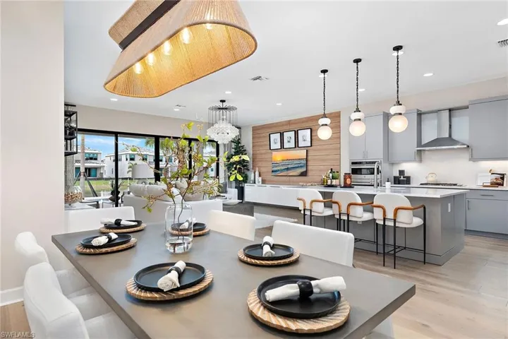 Dining space with a notable chandelier and light wood-type flooring