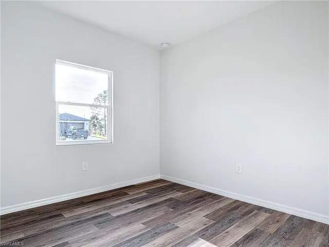 Empty room with baseboards and wood finished floors