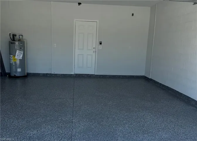 Garage with concrete block wall and water heater