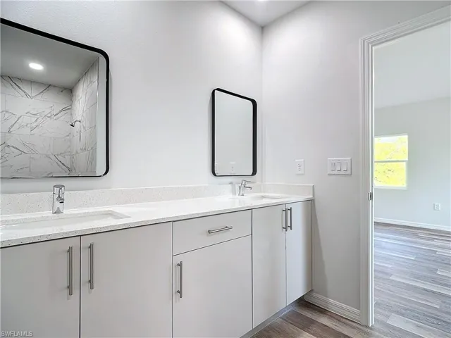 Bathroom with light wood-style floors and double vanity