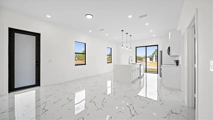 Unfurnished room featuring light marble finish flooring and recessed lighting