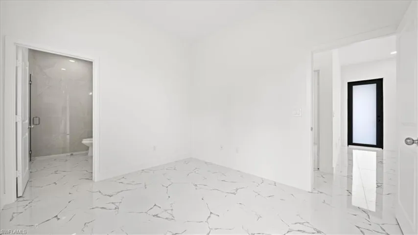 Spare room with light marble finish floors and recessed lighting