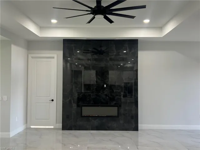 Statement fireplace featuring large-format dark-toned tile, integrating a modern linear electric insert