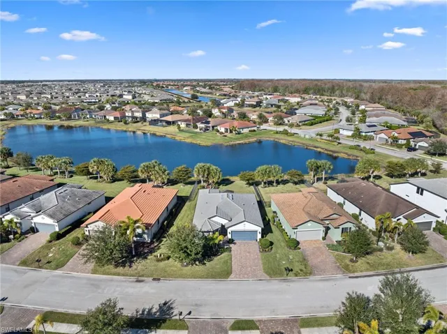 Aerial perspective of suburban area featuring a large body of water
