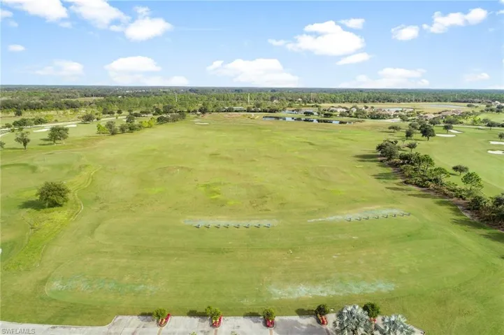 Bird's eye view of a golf course and a nearby body of water