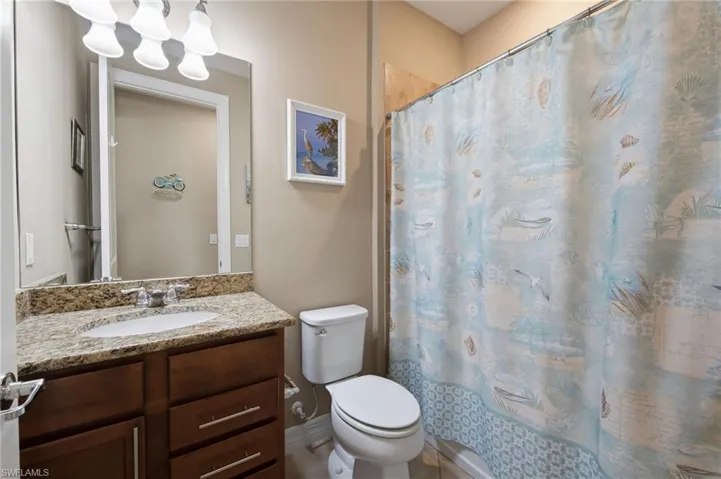Bathroom with vanity and shower / bath combo with shower curtain