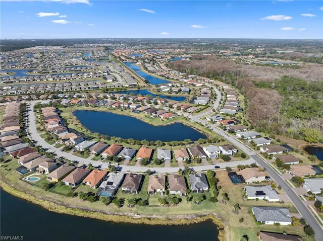 Aerial view of property's location featuring a large body of water and nearby suburban area