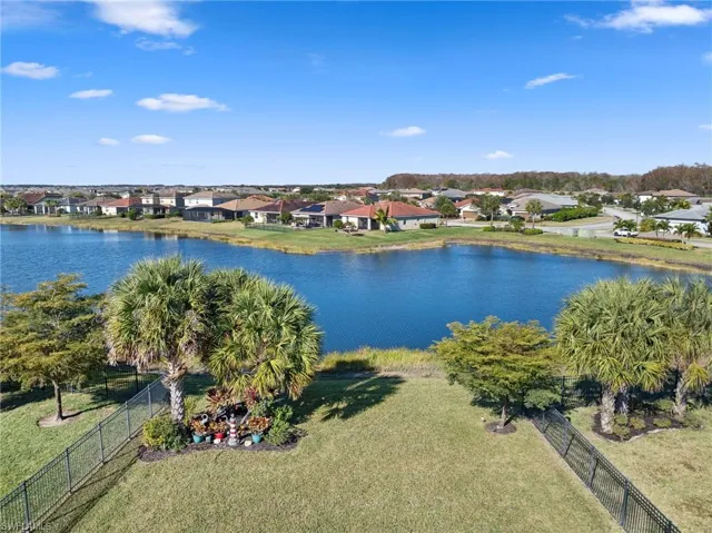 Aerial perspective of suburban area featuring a large body of water