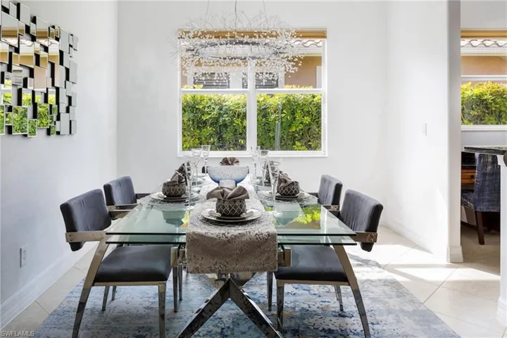 Dining room featuring light tile patterned floors and a chandelier