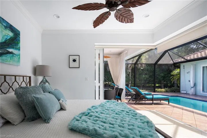 Bedroom with a sunroom, access to outside, tile patterned floors, crown molding, and a ceiling fan