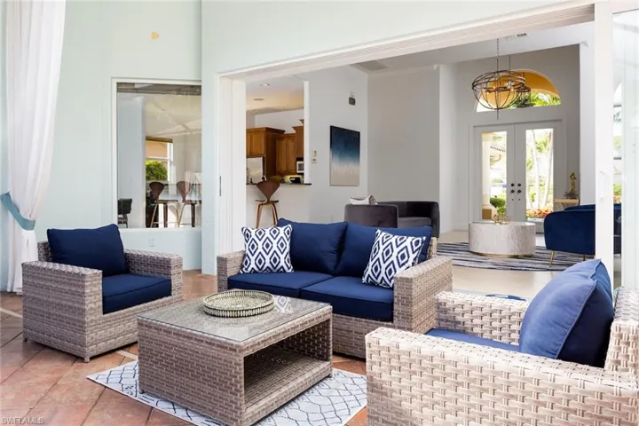 Tiled living room featuring french doors