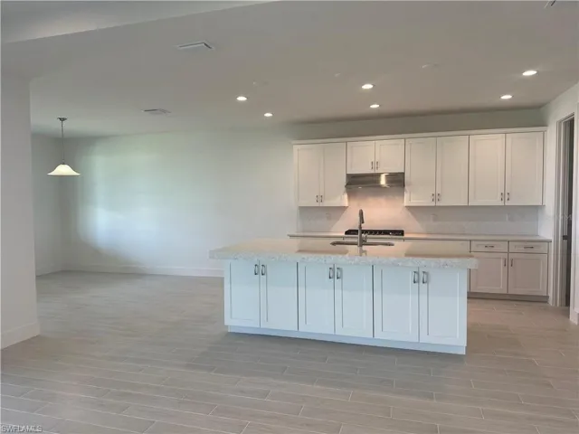 Chef's kitchen with Whirlpool stainless steel appliances, Viatera quartz countertops, soft-close cabinets and drawers