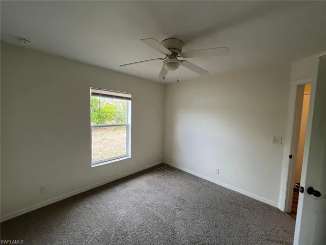 Unfurnished room with carpet and ceiling fan