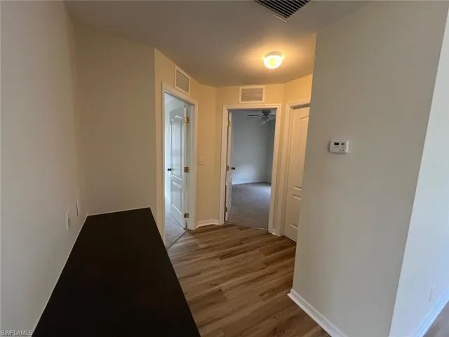Corridor with light wood finished floors and baseboards
