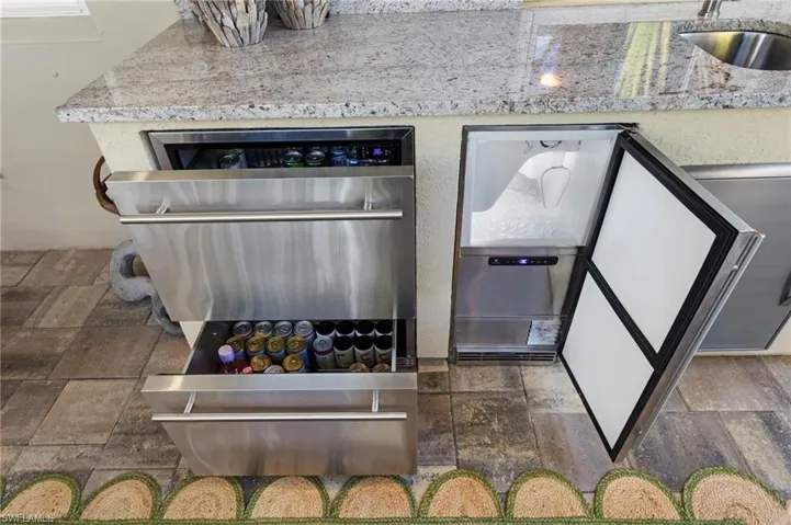Outdoor kitchen features GRANITE COUNTER/BACKSPLASH, new REFRIGERATOR DRAWERS and ICE MAKER (May 2022).