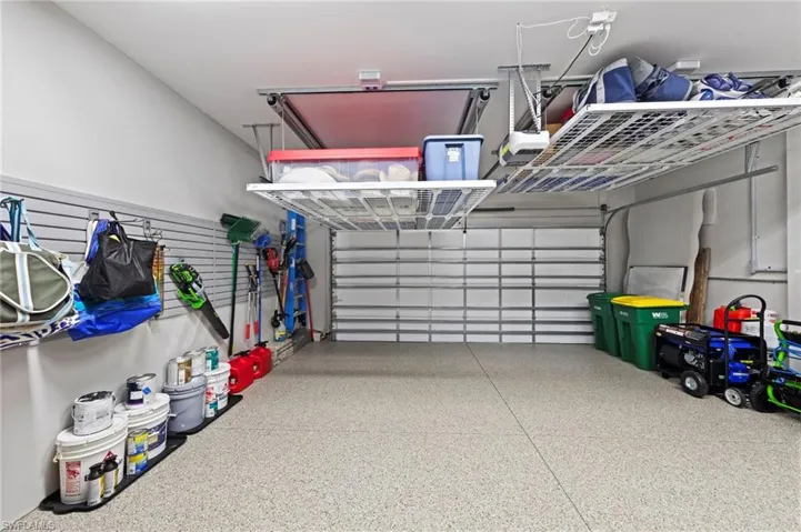 Garage features extensive storage solutions and CUSTOM UPGRADES. New GARAGE DOOR INSULATION & ATTIC INSULATION (June 2023), new AUTOMATED CEILING STORAGE SYSTEMS (2) (June 2023), new CUSTOM CABINET/SLAT WALL ORGANIZERS (September 2021)