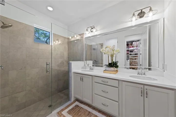 Spacious primary bath with full shower, dual sink vanity and water closet. New added CAN LIGHTING (September 2023), new FRAMELESS GLASS SHOWER DOOR (February 2022), new BEVELED MIRROR (February 2022), new LIGHT FIXTURES (November 2021)