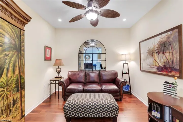 Den with wood floors, ceiling fan and pocket door added to enclose den!