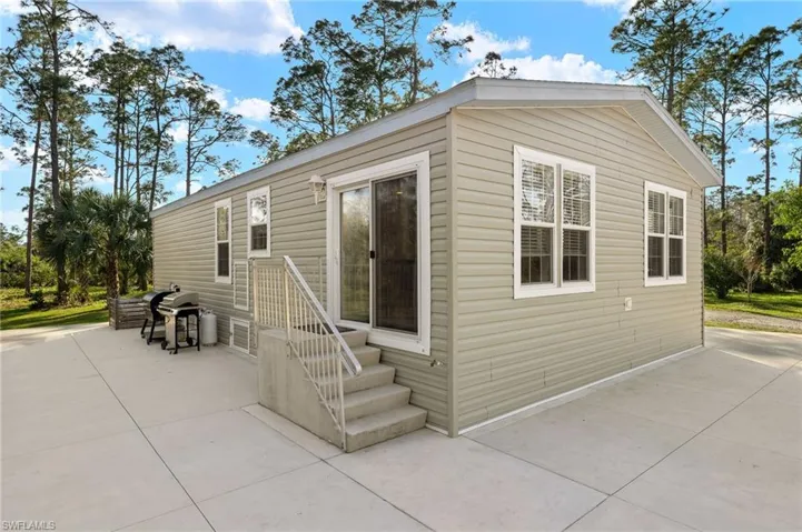 Back entry of home with sliding glass doors