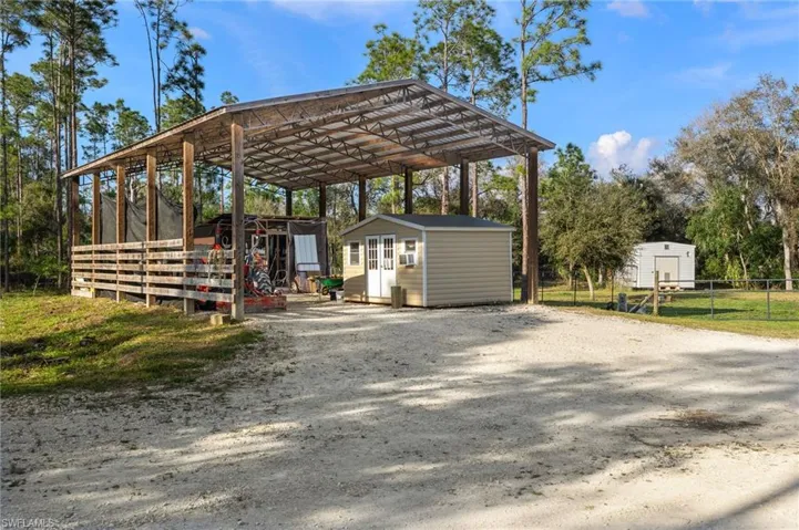 View of car parking with a pole barn