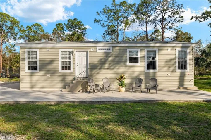 Front of house featuring a lawn and a patio