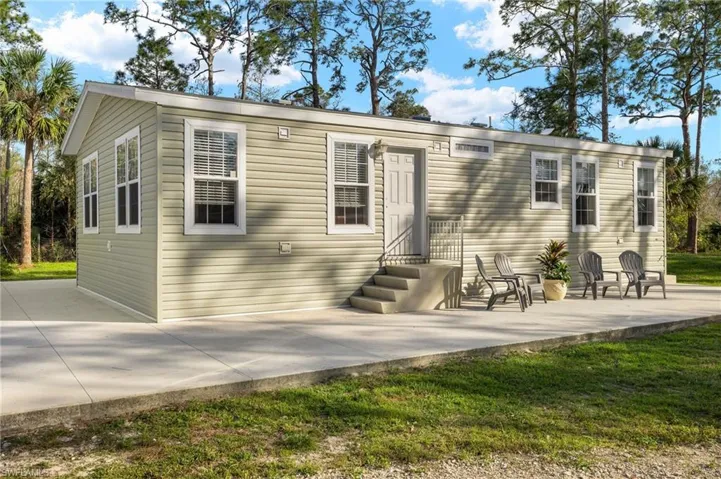 Front of property with a lawn and a patio area