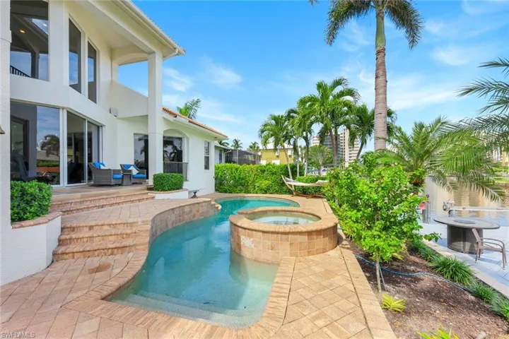 View of pool featuring a patio and a pool with connected hot tub