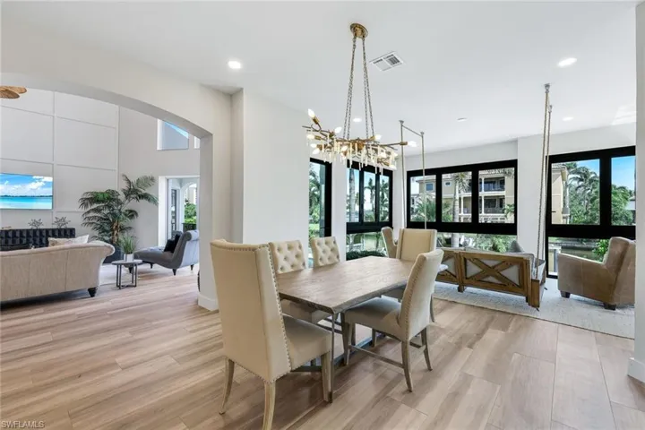 Dining space featuring a chandelier, light wood-style flooring, and recessed lighting