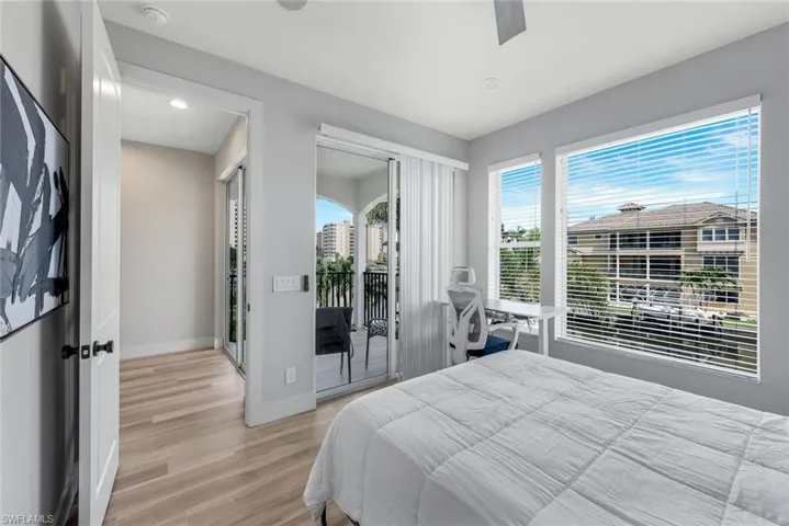 Bedroom with light wood-type flooring, access to exterior, a ceiling fan, and recessed lighting