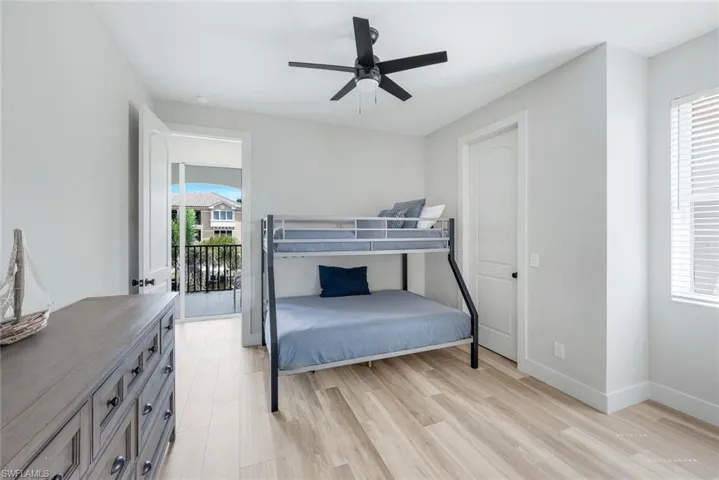 Bedroom with light wood finished floors and ceiling fan