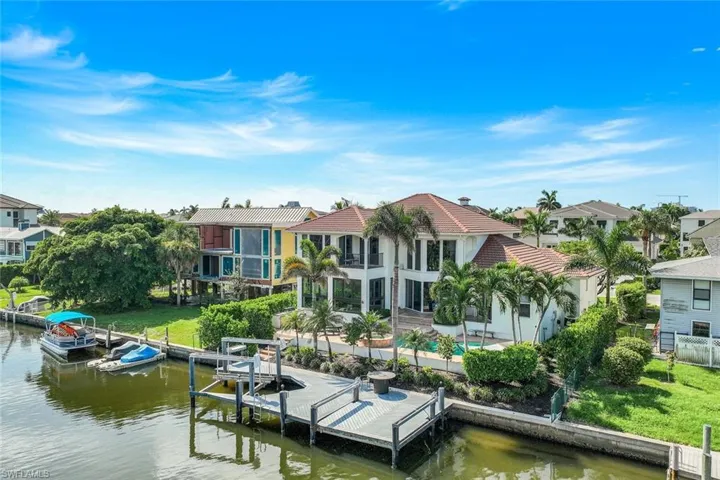 Dock area with a water view and a lawn