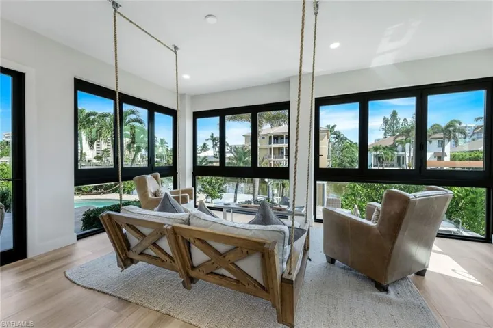 Sunroom with healthy amount of natural light, recessed lighting, and wood finished floors