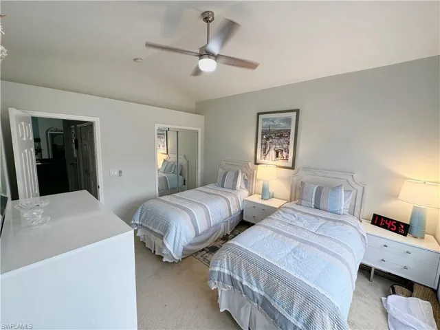 Carpeted bedroom with lofted ceiling, a closet, and ceiling fan