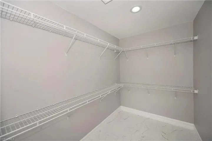 Spacious closet with marble finish floor